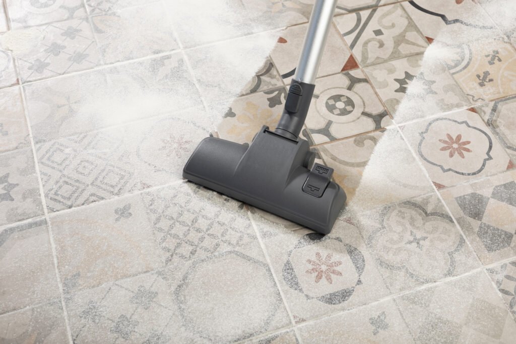 cleaning floor with modern vacuum cleaner in kitchen room. easy cleaning with vacuum cleaner